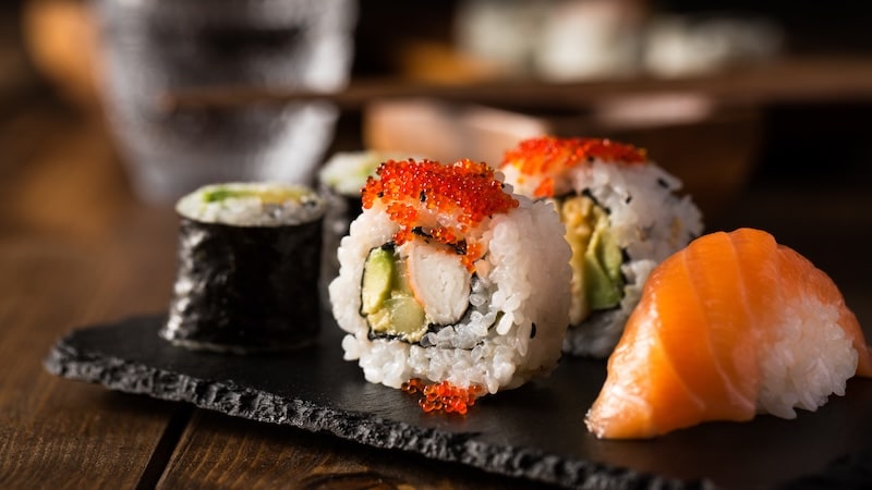Fresh and delicious maki and nigiri sushi and sake glass.